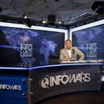 Infowars studio broadcast setup with host and digital screens
