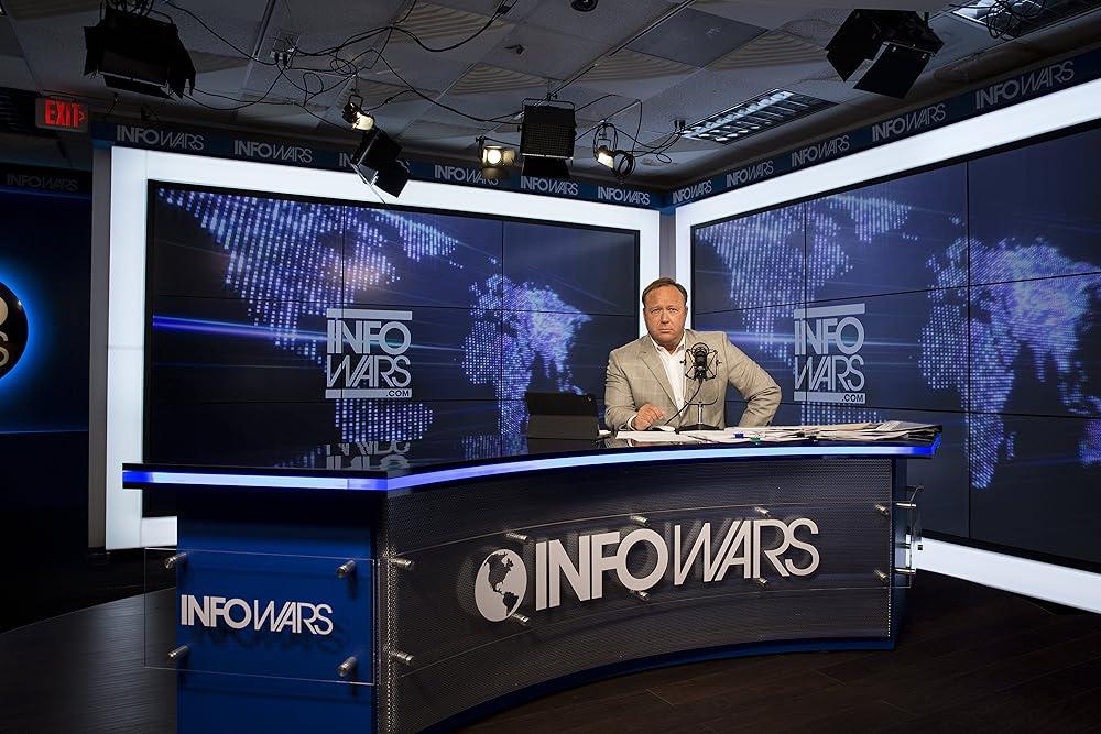 Infowars studio broadcast setup with host and digital screens