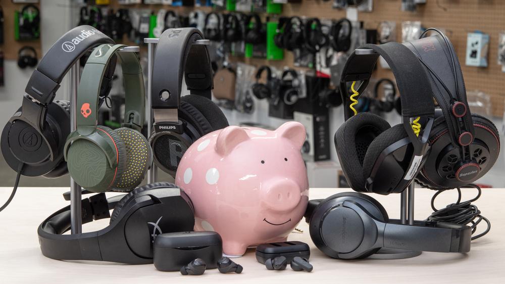 Bluetooth headphones shopping concept with piggy bank and audio gear representing budget buying options